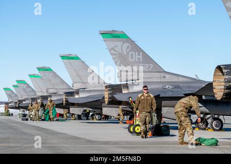 U.S. Air Force maintenance personnel, assigned to Ohio National Guard’s 180th Fighter Wing, perform post-flight inspections after a training flight at Joint Base Elmendorf-Richardson, Alaska, during U.S. Northern Command Exercise ARCTIC EDGE 2022, March 14, 2022.  AE22 is a biennial defense exercise for U.S. Northern Command and Canadian Armed Forces to demonstrate and exercise a joint capability to rapidly deploy and operate in the Arctic. Stock Photo