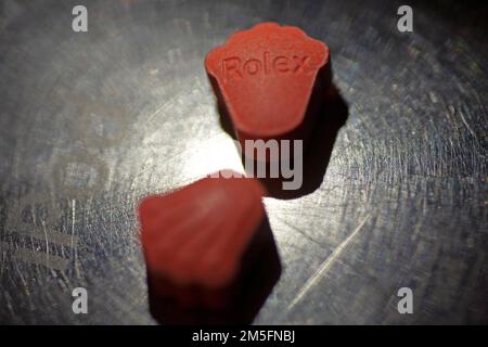 Orange pills with mdma ecstasy dope rolex drug close up background