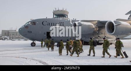 Members of the Royal Canadian Air Force from 3 Wing, Bagotville, Quebec, board a Royal Canadian Air Force CC-17 Globemaster for Thule AFB, Greenland, to participate in NORAD Operation Noble Defender, March 14, 2022.    NORAD Operation NOBLE DEFENDER 22-2 is an air defence operation that runs from from March 14 to 17, 2022, involving a variety of military aircraft from the Royal Canadian Air Force (RCAF) and United States Air Force. Personnel and aircraft are based out of Canadian Forces Station Alert, Nunavut; Whitehorse, Yukon; Yellowknife, Northwest Territories; and 5 Wing Goose Bay, Newfoun Stock Photo