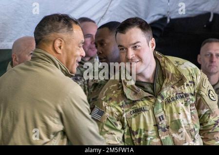 Gen. Michael Garrett, commanding general of U.S. Forces Command, shakes hands with Capt. Brady Carroll and other staff officers from 4th Infantry Brigade Combat Team (Airborne), 25th Infantry Division, during a visit to Joint Pacific Multinational Readiness Center rotation 22-02 near Fort Greely, Alaska, March 15, 2022. Gen. Garrett is the first commander of 4-25 IBCT (ABN), standing up the brigade combat team in 2005. Joint Pacific Multinational Readiness Capability 22-02, conducted from March 9 to 24, 2022 at locations around Alaska, is a Regional Combat Training Center rotation, which offer Stock Photo