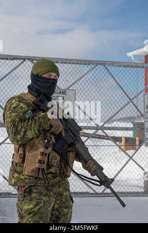 Wing Auxiliary Security Force (WASF) personnel verify member's  identification and security clearance before allowing entry to the Forward  Operating Location in Yellowknife, Northwest Territories March 15, 2022.  NORAD Operation NOBLE DEFENDER 22-2