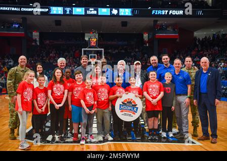 Col. Patrick Miller (far left), 88th Air Base Wing commander, and Lt. Gen. Shaun Q. Morris (top row, second from right), Air Force Life Cycle Management Center commander, join committee members and Big Hoopla STEM Challenge participants for a group photo March 15, 2022, at University of Dayton Arena. Since 2012, the Big Hoopla has showcased Dayton’s collaborative spirit, community support and military appreciation as host of the NCAA men's basketball tournament First Four. Stock Photo