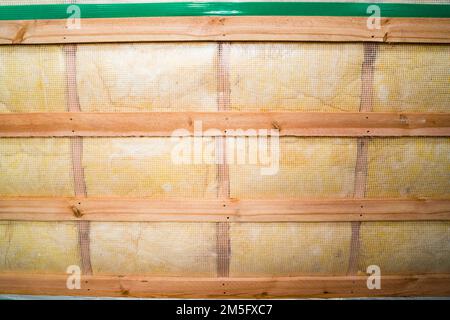 Glass wool is laid between the roof rafters and closed with a vapor barrier, view from below Stock Photo