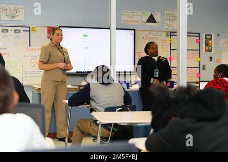 Ens. Amanda Clark, from Las Vegas, assigned to Naval Computer and Telecommunications Area Master Station, Atlantic, left, and Yeoman 1st Class Jazzette Bailey, from Sparta, Georgia, assigned to USS Gerald R. Ford (CVN 78), speaks to Savannah High School students during a Savannah Navy Week visit, March 15, 2022. Navy Week is an annual series of events held throughout the year in various U.S. cities without a significant Navy presence to provide an opportunity for citizens to interact with Sailors and learn about the Navy and its capabilities. The Fleet Outreach Ambassador Team is a delegation Stock Photo