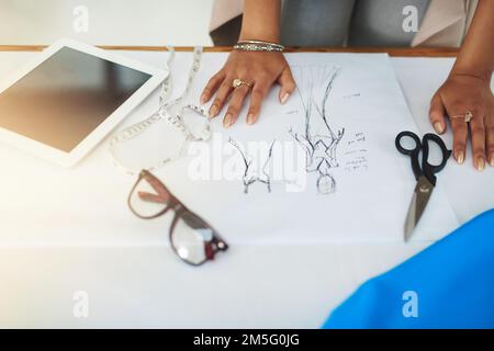 Sketch your ideas. a fashion designer working on a new design. Stock Photo