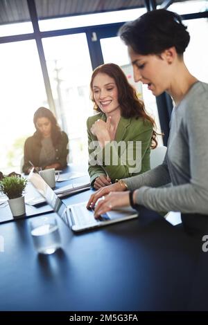 Making notes of all the details. a group of businesswomen working in an office. Stock Photo
