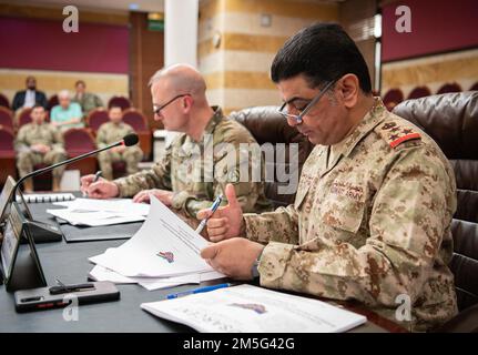 Maj. Gen. Wendul Hagler, the deputy commanding general of U.S. Army Central Command, along with Brig. Gen. Fahad Al-Otaibi, the director of Kuwaiti Military Cooperation Office, Kuwaiti Army, sign the minutes concluding the 7th annual Biannual Project Financial Management Review, held at the Kuwait Ministry of Defense, Kuwait City, on Mar. 16, 2022. Stock Photo