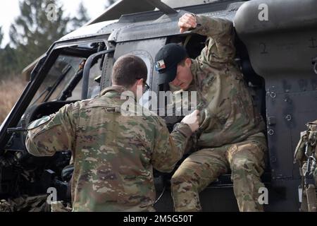 U.S. Army Soldiers prepare an M240H for the Alpha Company 2nd Battalion, 227th Aviation Regiment, 1st Air Cavalry weapon’s qualification at Grafenwoehr Training Area, Germany, March 16, 2022. The unit must perform an annual qualification which entails firing the weapon from a UH-60 Blackhawk. Stock Photo