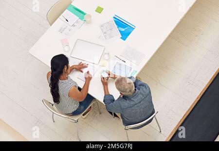 All prepped for a productive meeting. a two colleagues having a meeting in a modern office. Stock Photo