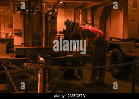 U.S. Marines with 3rd Landing Support Battalion, 3rd Marine Logistics Group, conduct preventative maintenance checks and services of military equipment aboard the USNS 1st Lt Jack Lummus (T-AK 3011) during exercise Atlantic Dragon on Marine Corps Support Facility Blount Island, Florida, United States, March 16, 2022. Atlantic Dragon is a force generation exercise pushing Combat Logistics Regiment 37 as an arrival assembly operations group to provide tactical logistics support to III Marine Expeditionary Force. The exercise consists of an experimental maritime prepositioned force's offload tact Stock Photo