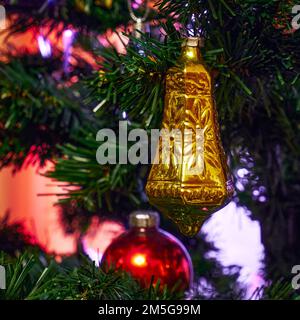 Decoration in the form of a golden bell on a Christmas tree close-up Stock Photo
