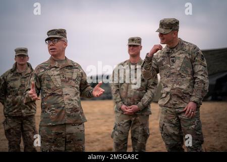 Maj. Gen. Greg Brady, commanding general of the 10th Army Air and Missile Defense Command, speaks with leaders and Soldiers of the 5th Battalion, 7th Air Defense Artillery Regiment about the importance of their mission at a forward-deployed Patriot Missile site in southeastern Poland on March 16, 2022. The 10th AAMDC, by order of the EUCOM Commander, has repositioned two Patriot batteries to Poland as a prudent defensive measure to counter any potential threat to U.S. and Allied forces and NATO territory. Stock Photo