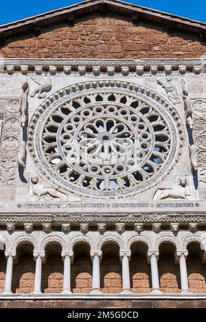 13th century Rose window, sculptures and loggia on the facade of the 8th century Romanesque Basilica church of St Peters, Tuscania, Lazio, Italy Stock Photo
