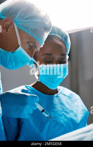 Focused on the operation. two surgeons operating on a patient in a hospital. Stock Photo