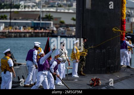 Sailors assigned to the Virginia-class fast-attack submarine USS Minnesota (SSN 783) heave mooring lines as the boat makes its homecoming arrival at Joint Base Pearl Harbor-Hickam after completing a change of homeport from Groton, Connecticut. The submarine’s ability to support a multitude of missions, including anti-submarine warfare, anti-surface warfare, strike warfare, and surveillance and reconnaissance has made Minnesota one of the most capable and advanced submarines in the world. Stock Photo