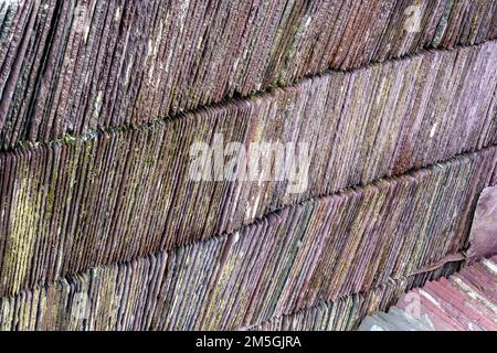 Stack of vintage roof slates showing weathered colours Stock Photo
