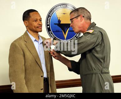 220317-N-N0443-0004 PENSACOLA, Fla. (Mar. 17, 2022) Rear Adm. Pete Garvin, commander of Naval Education and Training Command, presents a Navy Civilian Service Achievement Medal to Mr. Eric Green, a human resources specialist for Military Manning (N122) in Pensacola, Fla., during a hybrid award ceremony in the NETC headquarters aboard Naval Air Station Pensacola Mar. 17. Green received the medal and a plaque for being selected as the NETC senior civilian of the quarter for first quarter fiscal year (FY) 2022. Stock Photo