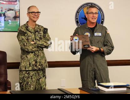 220317-N-N0443-0003 PENSACOLA, Fla. (Mar. 17, 2022) Naval Education and Training Command Force Master Chief Matthew Harris and Rear Adm. Pete Garvin, NETC commander, present a plaque virtually to Mr. Steven Roeseler, a product line analyst for NETC Supply Chain Operations (N31) in Millington, Tenn., during a hybrid award ceremony in the NETC headquarters aboard Naval Air Station Pensacola Mar. 17. Roesler received the plaque and a Navy Civilian Service Achievement Medal for being selected as the NETC junior civilian of the quarter for first quarter fiscal year (FY) 2022. Stock Photo