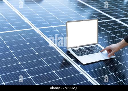 Laptop with blank screen on a solar panel Stock Photo