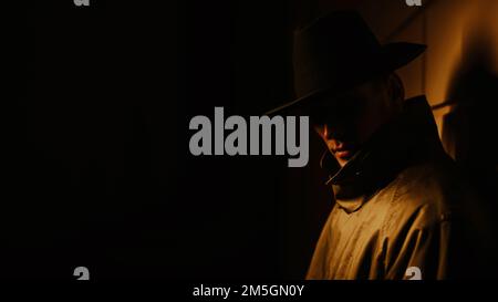 mysterious portrait in the noir style of a male detective at night Stock Photo