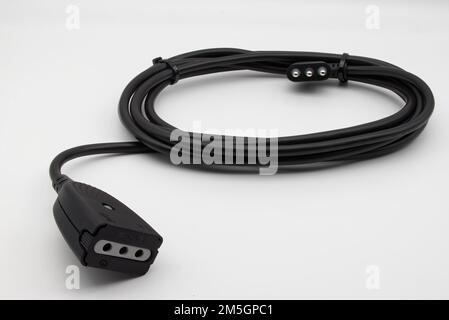 Black extension cord isolated on white background. Stock Photo