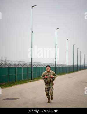 A U.S. Army paratrooper assigned to the 173rd Airborne Brigade runs in his body armor during a physical training competition at Caserma Del Din in Vicenza, Italy, March 17, 2022.    The 173rd Airborne Brigade is the U.S. Army's Contingency Response Force in Europe, providing rapidly deployable forces to the United States European, African, and Central Command areas of responsibility. Forward deployed across Italy and Germany, the brigade routinely trains alongside NATO allies and partners to build partnerships and strengthen the alliance. Stock Photo