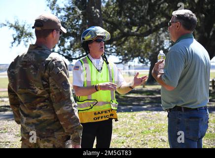 Gary Pierson, 81st Civil Engineering Squadron assistant fire chief, discusses the exercise scenario with U.S. Air Force Maj. Daniel Lambert, 81st Training Wing inspector general, and William Mays, 81st TRW inspections specialist, during an Antiterrorism, Force Protection and Chemical, Biological, Radiological, Nuclear exercise at Keesler Air Force Base, Mississippi, March 17, 2022. The exercise tested the base's ability to respond to and recover from a mass casualty event. Stock Photo