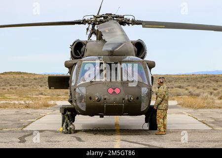 A UH-60 Black Hawk helicopter assigned to 2-158 Assault Helicopter Battalion, 16th Combat Aviation Brigade, conducts pre-flight activities at Orchard Combat Training Center on Mar. 17, 2022. The aircrew was transporting Soldiers to and from Joint Base Lewis-McChord, Wash. Stock Photo