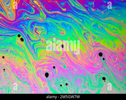 Colourful light diffraction patterns formed by oil droplets floating on ...