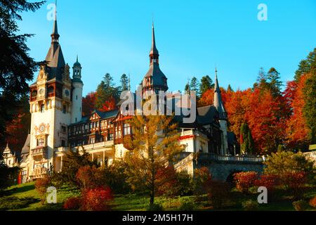 The beautiful Peles Castle (Castelul Peles) in Sinaia, Romania with autumn trees Stock Photo
