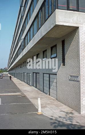 A view looking east along Mansfield Road at one of the blocks of flats that formed the Ludham and Waxham Estate, Camden, London, England, UK in the late 1970s. The scheme was designed by architects Fredrick MacManus and Partners for London Borough of Camden, and was built between 1974 and 1979. The estate was one of the largest social housing estates in Camden with homes for 276 households – a vintage 1970s photograph. Stock Photo