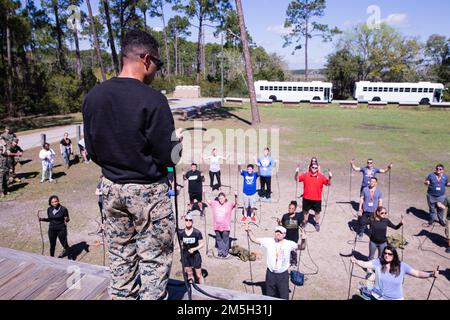 Educators learn about rope tying in order to create a harness for rappelling in South Carolina on March 16, 2022. The Educators Workshop brings different teachers, community leaders, and influencers from around the country in order to showcase the process of making a Marine. (United States Marine Corps photo by Cpl. Cheng Chang) Stock Photo