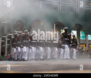 U.S. Marines with the Marine Corps Silent Drill Platoon march along Fifth Avenue during the New York City St. Patrick’s Day Parade in New York, Mar. 17, 2022. The Silent Drill Platoon is a 24-Marine rifle platoon that has been performing unique precision drill across the world for more than 70 years. Stock Photo