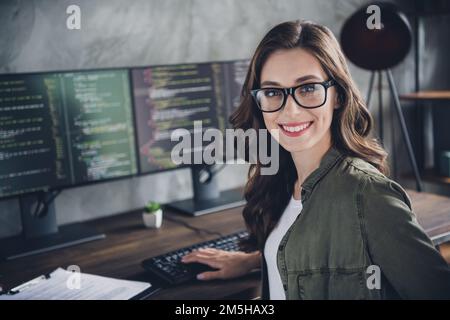 Portrait of cheerful intelligent manager lady toothy smile operating pc typing code workstation business center indoors Stock Photo
