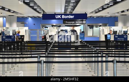 A member of the military at passport control at Manchester airport as they cover for striking Border Force officers. Public and Commercial Services union (PCS) members working as Border Force officers at Gatwick, Heathrow, Birmingham, Cardiff, Manchester and Glasgow airports and the port of Newhaven resumed strikes on Wednesday for four days over pay, jobs and conditions. Picture date: Thursday December 29, 2022. Stock Photo