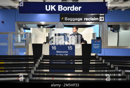 A member of the military at passport control at Manchester airport as they cover for striking Border Force officers. Public and Commercial Services union (PCS) members working as Border Force officers at Gatwick, Heathrow, Birmingham, Cardiff, Manchester and Glasgow airports and the port of Newhaven resumed strikes on Wednesday for four days over pay, jobs and conditions. Picture date: Thursday December 29, 2022. Stock Photo