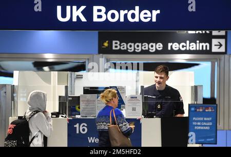 A member of the military at passport control at Manchester airport as they cover for striking Border Force officers. Public and Commercial Services union (PCS) members working as Border Force officers at Gatwick, Heathrow, Birmingham, Cardiff, Manchester and Glasgow airports and the port of Newhaven resumed strikes on Wednesday for four days over pay, jobs and conditions. Picture date: Thursday December 29, 2022. Stock Photo