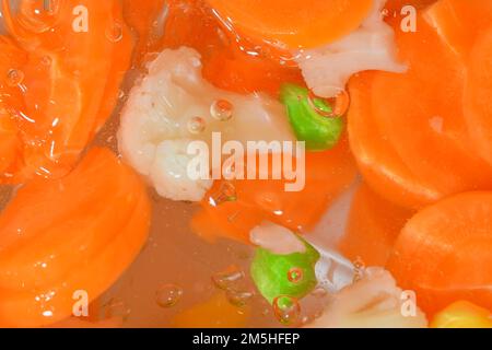Close-up fresh soup vegetables with carrots, peas, cauliflower and corn on white background. Soup vegetables with carrots, peas, cauliflower and corn Stock Photo