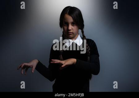 a girl Wednesday Addams. Halloween party Stock Photo