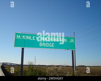 Edisto Island National Scenic Byway - Sign for McKinley Washington, Jr. Bridge. The start of Edisto Island Scenic Byway is indicated by a large sign at the base of McKinley Washington, Jr. Bridge. The sweeping bridge joins Edisto Island to the mainland. Location: South Carolina (32.611° N 80.345° W) Stock Photo