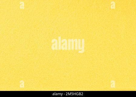 Yellow felt full frame abstract background and texture. Copy space. Stock Photo