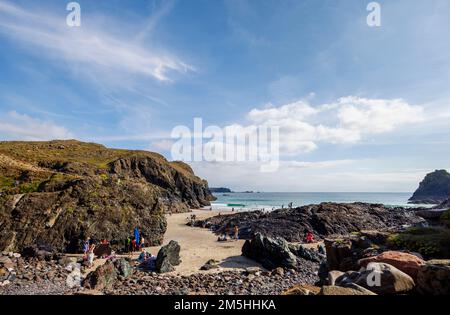 View of the sandy and rocky beach and cliffs in afternoon sun at Kynance Cove on the Lizard Peninsula, south coast of Cornwall, south-west England Stock Photo