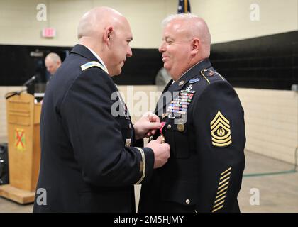 U.S. Army Col. Anthony Poole, chief of staff of the Georgia Army National Guard, presents the Legion of Merit to Command Sgt. Maj. Joseph Shirer March 18, 2022, in Canton, Georgia. Shirer retired after serving nearly 30 years in the U.S. Army and Georgia Army National Guard. Stock Photo