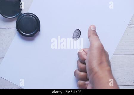 putting fingerprints on a paper close up , Stock Photo
