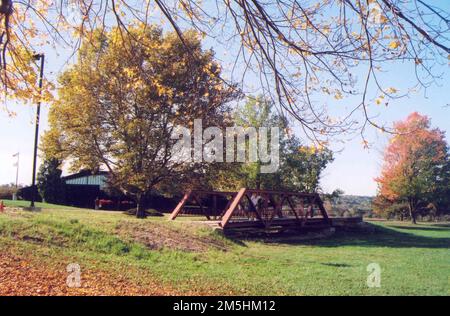 Historic National Road - Outside the Zane Grey Museum. A fall tree conceals the Zane Grey Museum in the background. In the foreground is a small, charming bridge. Zanesville, Ohio (39.943° N 82.011° W) Stock Photo