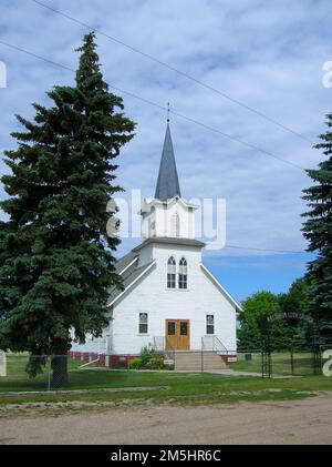 Sheyenne River Valley Scenic Byway - Waldheim Church. This simple white wooden structure stands out on the Sheyenne River Valley. The Waldheim Church was completed in 1900 on land donated by a local landowner. Location: North Dakota (46.667° N 97.935° W) Stock Photo