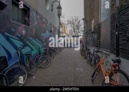 Many bikes on a narrow alley in Amsterdam, the Netherlands Stock Photo