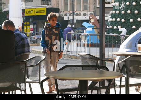 Beirut, Lebanon. 27th Dec, 2022. A Syrian boy begs barefoot in a coffee shop in Beirut, Lebanon, December 27 2022. Despite UNHCR, the UN refugee Agency, and many other NGOs provide Syrian refugees with help in Lebanon, many children are exploited by traffick. (Photo by Elisa Gestri/SIPA USA) Credit: Sipa USA/Alamy Live News Stock Photo