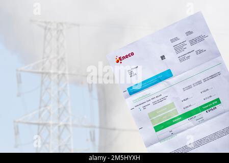 Eneco invoice, Belgian producer and supplier of natural gas and electricity in front of Doel nuclear power station and transmission tower in Belgium Stock Photo