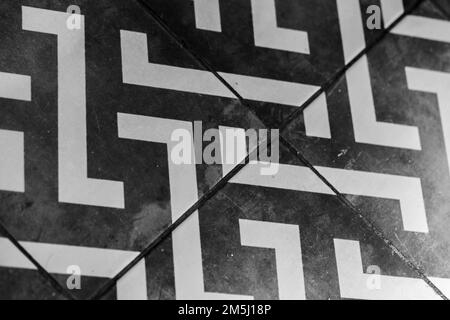 Vintage floor tiling with black and white geometric pattern, background photo Stock Photo